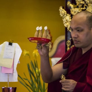 His Holiness Karmapa offering torma to dispel obstacles for the deceased at the beginning of the Jang Chok ritual